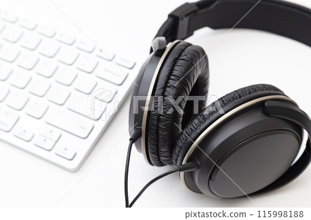 Headphones and computer on white background 115998188