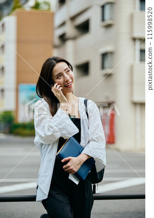 A young woman calling with a smartphone A young woman calling with a smartphone 115998520