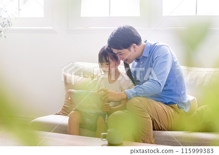Parents and children studying using a tablet 115999383