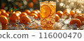 Iced tea with Orange, surrounded by orange and ice cubes 116000470