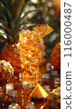 Iced tea with Pineapples, surrounded by pineapple and ice cubes 116000487
