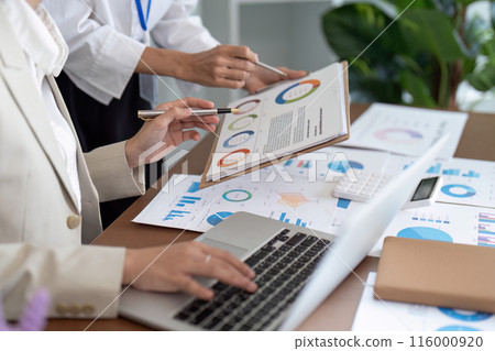 Business Team Analyzing Financial Data and Charts in Office Meeting for Strategic Planning 116000920