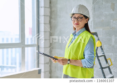 Portrait of woman builder engineer supervisor at construction 116001107