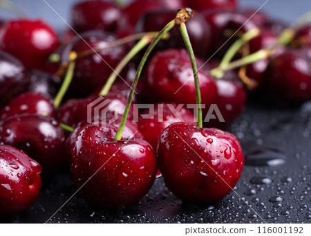 Fresh red cherries fruit. Fresh organic berries with leaves macro. 116001192