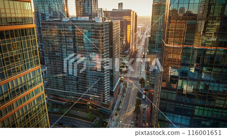 Cityscape with modern glass buildings and a warm sunlight glow. Captures the essence of urban development and corporate environments. Cityscape with modern glass buildings and a warm sunlight glow. Captures the essence of urban development and corporate environments. 116001651
