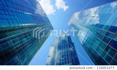 Low angle view of modern glass skyscrapers against a blue sky, symbolizing business growth and corporate success. Low angle view of modern glass skyscrapers against a blue sky, symbolizing business growth and corporate success. 116001873
