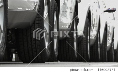 Wheels of convoy of the same cars on the asphalt Wheels of convoy of the same cars on the asphalt 116002571