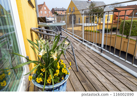 A large veranda or balcony with chairs and tables for relaxing on a summer day. A large veranda or balcony with chairs and tables for relaxing on a summer day. 116002890
