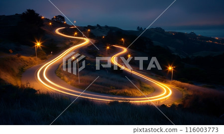 A winding hillside road lit by streetlights, guiding travelers to unseen destinations and hidden adventures. A winding hillside road lit by streetlights, guiding travelers to unseen destinations and hidden adventures. 116003773