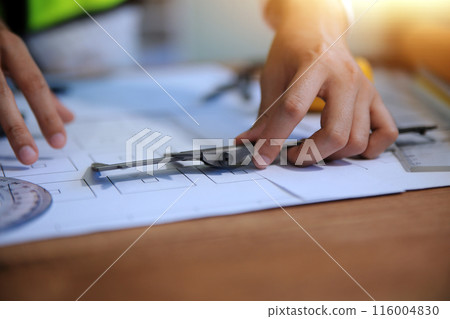 engineer people meeting working and pointing at a blueprint in office for discussing. Engineering tools and construction concept engineer people meeting working and pointing at a blueprint in office for discussing. Engineering tools and construction concept 116004830