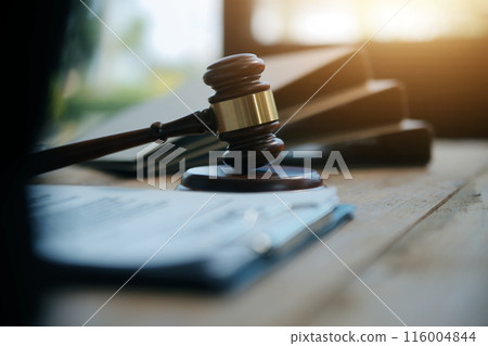 Judge gavel with Justice lawyers having team meeting at law firm background. Concepts of Law and Legal services. 116004844