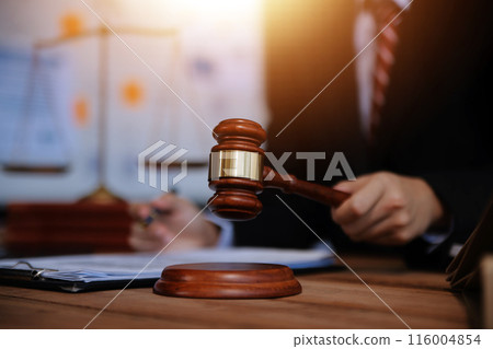 Judge gavel with Justice lawyers having team meeting at law firm background. Concepts of Law and Legal services. Judge gavel with Justice lawyers having team meeting at law firm background. Concepts of Law and Legal services. 116004854