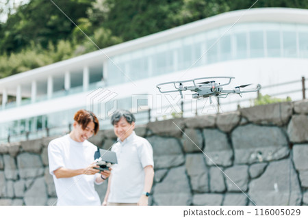 A video creator filming outdoors using a drone A video creator filming outdoors using a drone 116005029