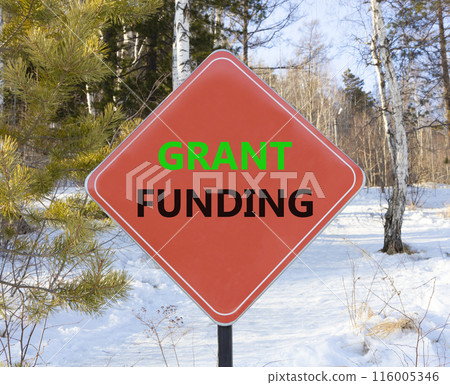 Grant funding symbol. Concept words Grant funding on beautiful red road sign. Beautiful forest snow blue sky background. Business and grant funding concept. Copy space. Grant funding symbol. Concept words Grant funding on beautiful red road sign. Beautiful forest snow blue sky background. Business and grant funding concept. Copy space. 116005346