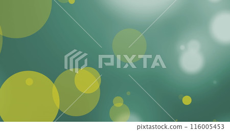 Image of yellow and white spots of light moving against green background 116005453