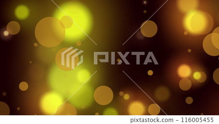 Image of glowing yellow and orange spots of light against black background 116005455