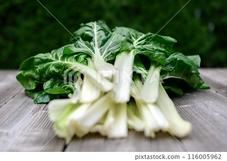 Bunch of organic chard with leaves on a rustic wooden table Bunch of organic chard with leaves on a rustic wooden table 116005962