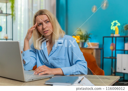 Tired ill businesswoman suffering from headache problem tension migraine stress at home office desk Tired ill businesswoman suffering from headache problem tension migraine stress at home office desk 116006012