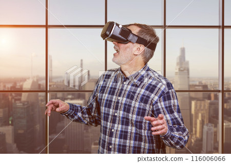 Portrait of excited elder man in vr headset. Checkered window background. 116006066