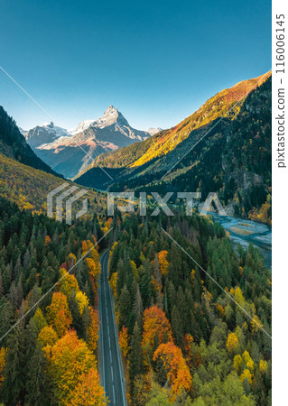 High angle aerial view of river and road running through forest and mountainous landscape High angle aerial view of river and road running through forest and mountainous landscape 116006145