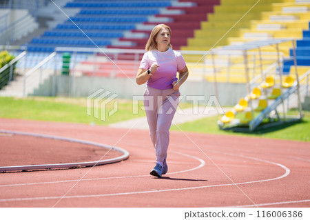 Elderly woman exercising. Fit senior lady running. Elderly woman exercising. Fit senior lady running. 116006386