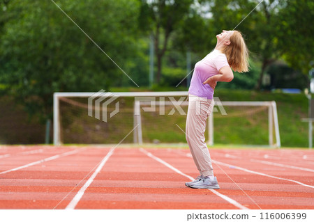 Elderly woman exercising. Fit senior lady running. 116006399