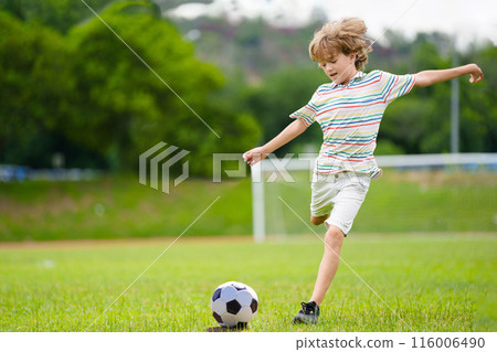 Child playing football. Kids play soccer. 116006490