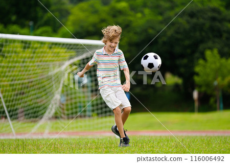 Child playing football. Kids play soccer. 116006492