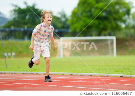 Child exercising. Kid running on stadium. Child exercising. Kid running on stadium. 116006497