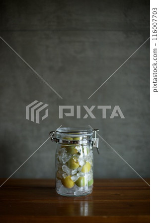 Plums and rock sugar placed in a glass jar to make syrup Plums and rock sugar placed in a glass jar to make syrup 116007703