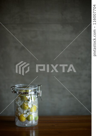 Plums and rock sugar placed in a glass jar to make syrup Plums and rock sugar placed in a glass jar to make syrup 116007704