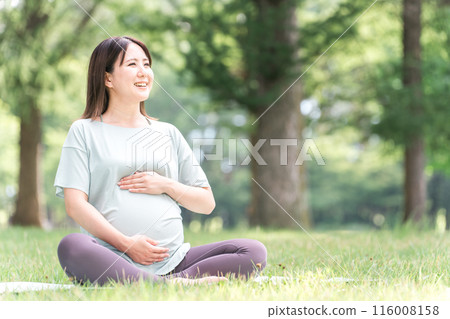 Young Asian woman doing maternity yoga, premama yoga, pilates and stretching in the forest and park Young Asian woman doing maternity yoga, premama yoga, pilates and stretching in the forest and park 116008158