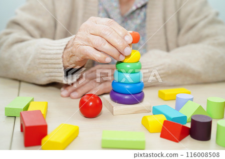 Asian elderly woman playing puzzles game for treatment dementia prevention and Alzheimer disease. 116008508