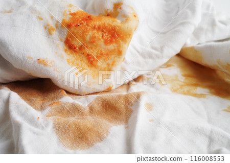 Dirty tomato sauce stain or ketchup on cloth to wash with washing powder, cleaning housework concept. 116008553