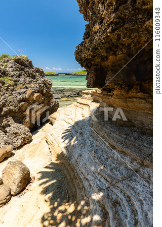 Beach seen between rocks 116009348