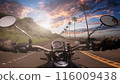 POV riding a motorcycle at sunset 116009438