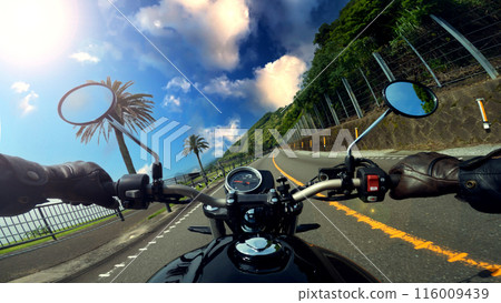 POV riding a motorcycle blue sky 116009439