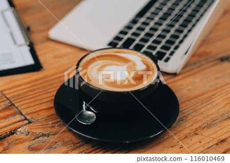 Closeup of coffee cup on table in empty corporate conference room before business meeting in office 116010469