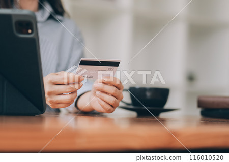 Happy asian woman using smartphone shopping online with credit card. Lifestyle. Easy pay using smart phone or digital device. 116010520