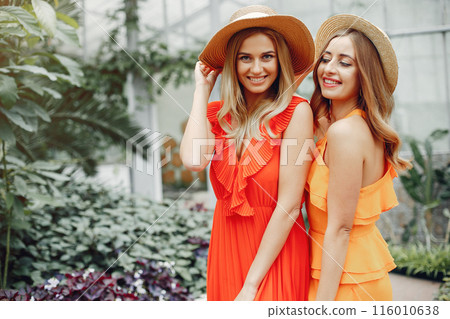 Beautiful girl in a red dress. Women in the greenhouse 116010638