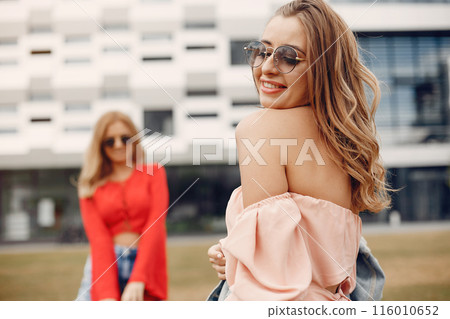 Beautiful girl in a red blouse. Women in a summer park. Beautiful girl in a red blouse. Women in a summer park. 116010652
