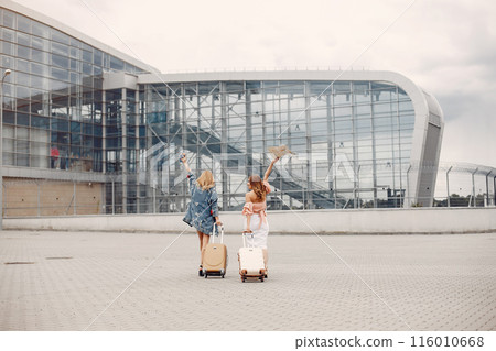 Girls at the airport. Friends with suitcasess Girls at the airport. Friends with suitcasess 116010668