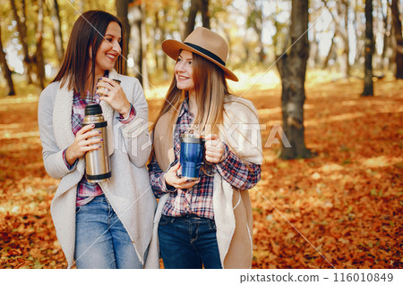 Beautiful girls in a park. Cute ladies in a stylish clothes 116010849