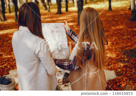 Beautiful girls in a park. Cute ladies in a stylish clothes 116010853