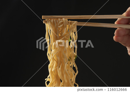 Cup noodles, instant ramen, pick up noodles with chopsticks 116012666