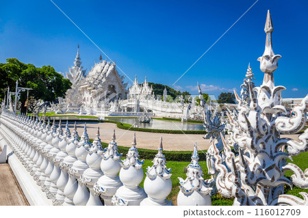 Beautiful and amazing white temple at Wat Rong Khun with blue sky background Chiang Rai, Thailand It is a tourist destination. Landmark of Chiang Rai 116012709