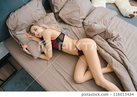 Woman Sleeping in Bed With Lace Bra and Matching Underwear 116013484