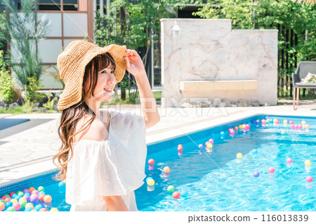 Profile of a young Asian woman in resort fashion by the pool at a resort (vacation, travel) Profile of a young Asian woman in resort fashion by the pool at a resort (vacation, travel) 116013839