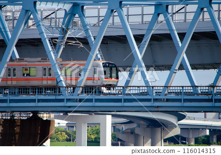 Toyo Rapid Railway train running over the Arakawa-Nakagawa Bridge on the Tokyo Metro Tozai Line 116014315