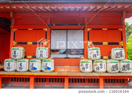 Fujinomiya, Japan April 8, 2024: Sake fermentation tank in Fujisan Hongu Sengen Taisha Shinto Shrine where cherry blossoms are blooming on a rainy day at Shizuoka, Japan. 116016164
